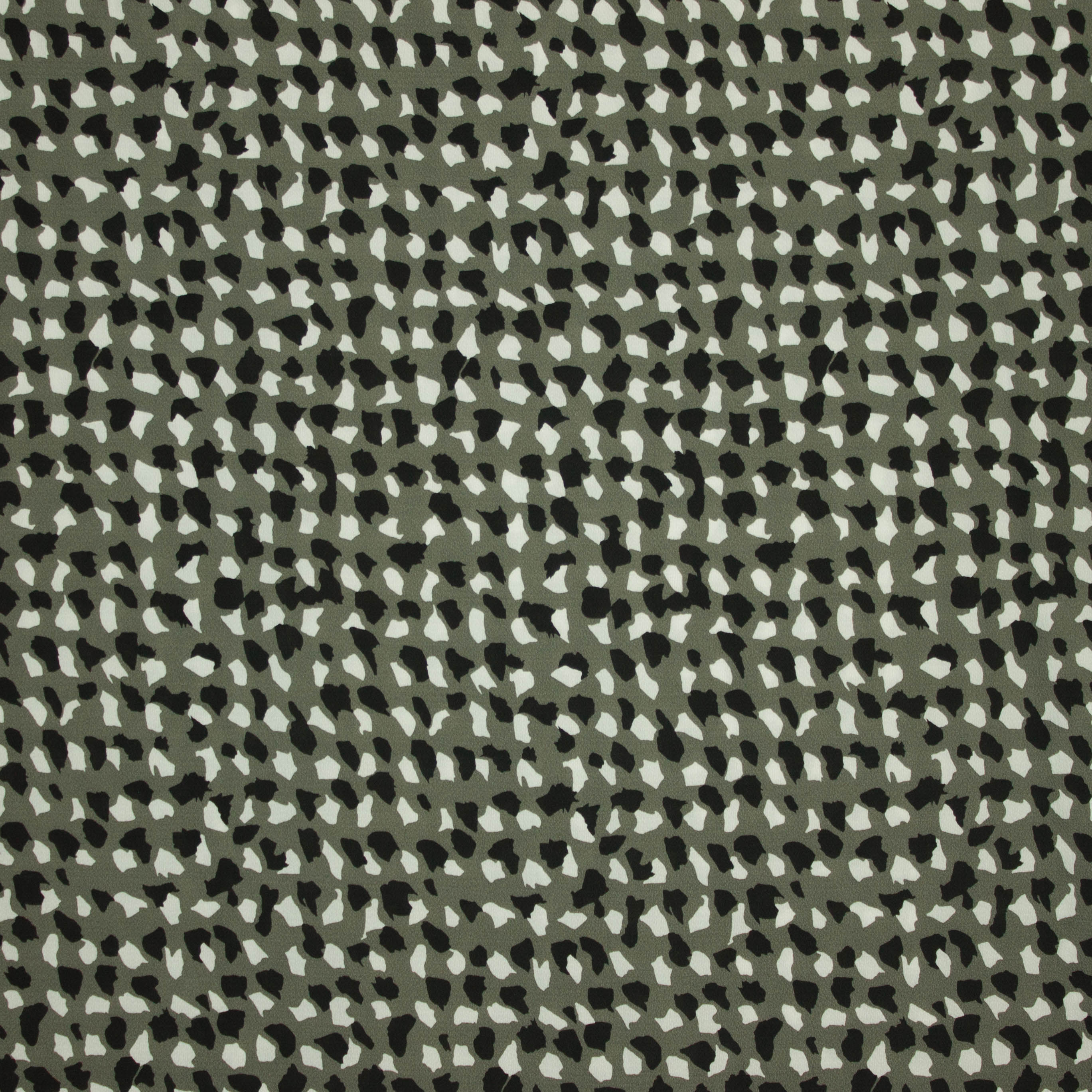 Polyester crêpe groen met witte en zwarte stippen
